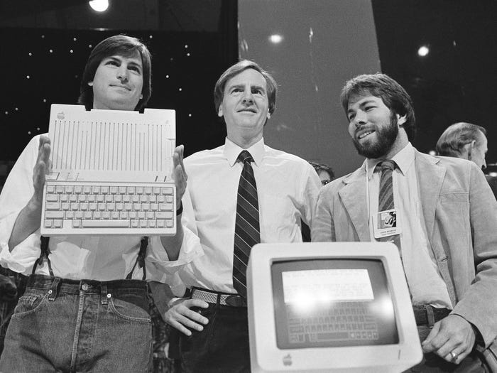 Steve Jobs (left), John Sculley (center), and Steve Wozniak unveil the new Apple II computer in San Francisco in 1984.